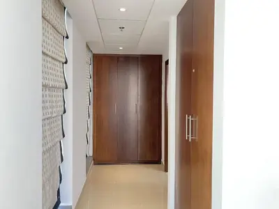 a hallway with a wooden door and a hallwayngth at Lux BnB Standpoint Tower Burj & Fountain Views in Dubai