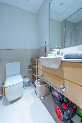 a bathroom with a white toilet and a sink at Luxury Escapes - Cozy Studio In front of Metro Stn - Access to Gym & Pool - Aura Azizi in Dubai