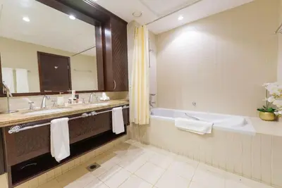 a bathroom with a tub and a sink and a bath tub at FIRST CLASS 3BR with full BURJ KHALIFA VIEW in Dubai