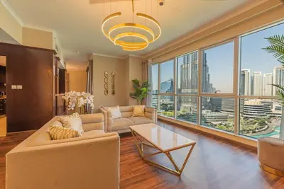 a living room with a couch and a large window at FIRST CLASS 3BR with full BURJ KHALIFA VIEW in Dubai