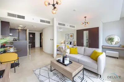 a living room with a couch and a table at Sunny Studio at Sky Gardens DIFC by Deluxe Holiday Homes in Dubai