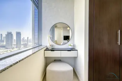 a bathroom with a mirror and a sink and a window at Best Value Modern 1BR with Pool & Stunning Views by Deluxe Holiday Homes in Dubai
