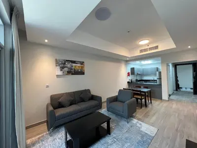 a living room with a couch and chairs and a table at Penrose Place Dubai JVC in Dubai