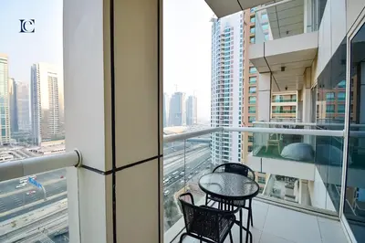 a balcony with two chairs and a table on a building at Luxury Escapes - Modern studio in West Avenue Dubai Marina in Dubai