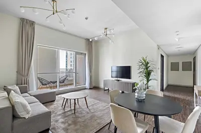 a living room with a couch and a table at Silkhaus with full Burj Khalifa & fountain view 1BDR in Downtown in Dubai