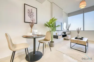 a dining room with a table and chairs at Opulent Studio at Sky Gardens DIFC by Deluxe Holiday Homes in Dubai