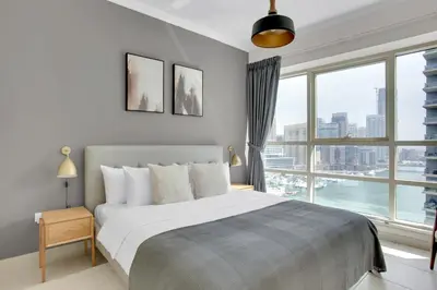 a bedroom with a large bed and a large window at Marina Quays West, Dubai Marina - Mint Stay in Dubai