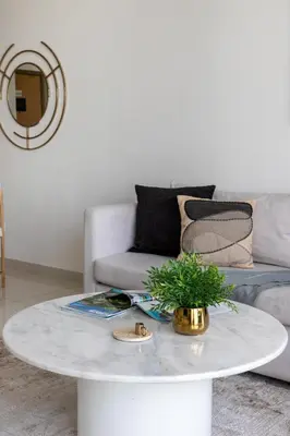 a white coffee table in a living room with a couch at Frank Porter - Paramount Midtown in Dubai