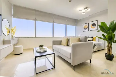 a living room with a couch and a table at Refreshing Studio at Sky Gardens DIFC by Deluxe Holiday Homes in Dubai