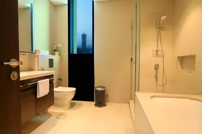 a bathroom with a shower and a toilet and a sink at Elegant Apartment with Direct access to Dubai Mall in Dubai