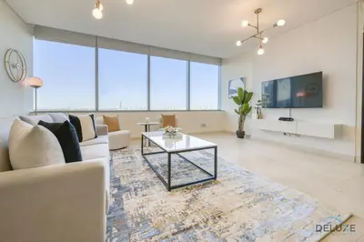 a living room with a couch and a table at Jubilant 1BR at Sky Gardens DIFC by Deluxe Holiday Homes in Dubai
