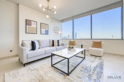 a living room with a white couch and a table at Jubilant 1BR at Sky Gardens DIFC by Deluxe Holiday Homes in Dubai