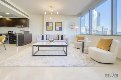 a living room with a couch and a table at Jubilant 1BR at Sky Gardens DIFC by Deluxe Holiday Homes in Dubai