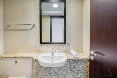 a bathroom with a sink and a mirror at Jubilant 1BR at Sky Gardens DIFC by Deluxe Holiday Homes in Dubai