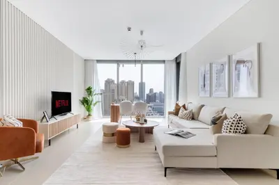 a living room with white furniture and a large window at GuestReady - Luxury l Sea Views Oasis in Dubai
