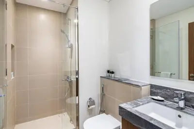 a bathroom with a shower and a sink and a toilet at GuestReady - Luxury l Sea Views Oasis in Dubai