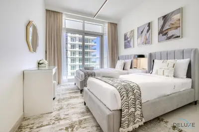 a hotel room with two beds and a couch at Exotic 2BR at Sunrise Bay Tower 1 Emaar Beachfront Dubai Marina by Deluxe Holiday Homes in Dubai