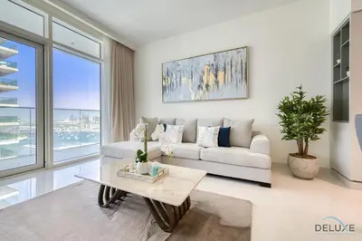 a living room with a couch and a table at Exotic 2BR at Sunrise Bay Tower 1 Emaar Beachfront Dubai Marina by Deluxe Holiday Homes in Dubai