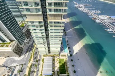 an aerial view of a building next to the water at Exotic 2BR at Sunrise Bay Tower 1 Emaar Beachfront Dubai Marina by Deluxe Holiday Homes in Dubai