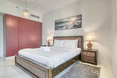 a bedroom with a large bed and two lamps at 300m From The Beach - JBR Apartment with Sea & Dubai Eye Views in Dubai