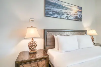 a bedroom with a bed and a table with a lamp at 300m From The Beach - JBR Apartment with Sea & Dubai Eye Views in Dubai