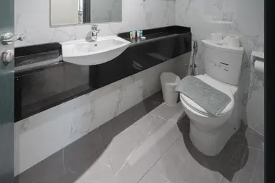 a bathroom with a toilet and a sink at Family-Sized 4BR Pool, Jacuzzi & Gym in Dubai