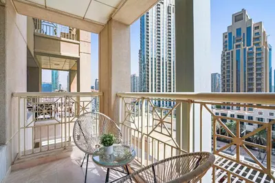 a balcony with two chairs and a table at Silkhaus cozy central studio in Downtown in 29 Boulevard in Dubai