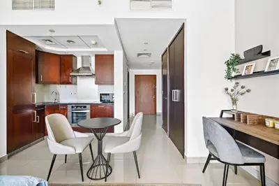a kitchen with a table and chairs in a room at Silkhaus cozy central studio in Downtown in 29 Boulevard in Dubai