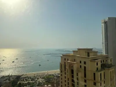 a building with a view of the beach and the ocean at STYLISH 2 BEDROOM SERVICE APARTMENT with SEA VIEW in Dubai