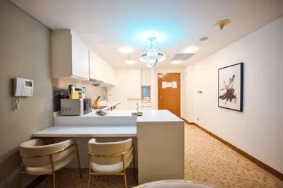 a kitchen with a counter and stools in a room at FAHH Stunning 1 BHK at Address Dubai Mall in Dubai