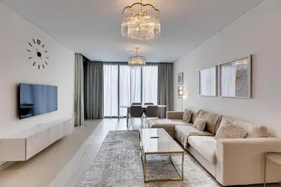 a living room with a couch and a tv at Sea View 2BD in new 52 42 tower Dubai Marina in Dubai