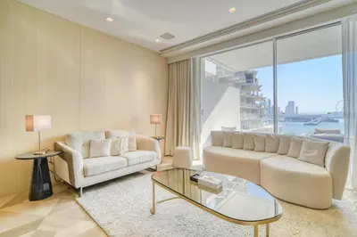 a living room with a couch and a glass table at FIVE Palm Jumeirah Residences - Mint Stay in Dubai