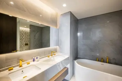 a bathroom with a white tub and a sink and a bath tubermott at FIVE Palm Jumeirah Residences - Mint Stay in Dubai