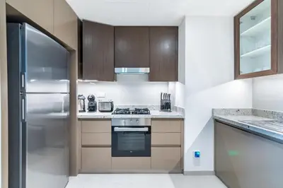 a kitchen with a stove and a refrigerator at GuestReady - Magnificent heart of Downtown in Dubai