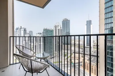 a balcony with a chair and a view of the city at GuestReady - Magnificent heart of Downtown in Dubai