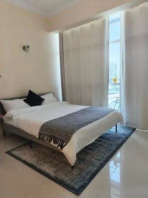 a bedroom with a large bed with a window at Studio in the heart of Sports City -great view & amenities! in Dubai