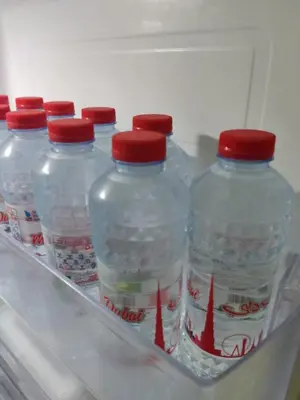 a group of plastic water bottles in a refrigerator at Studio in the heart of Sports City -great view & amenities! in Dubai