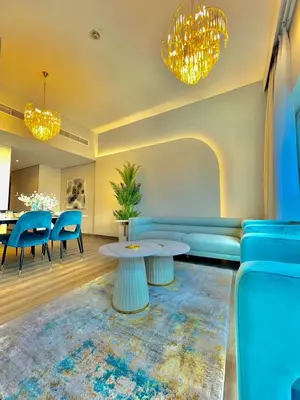 a living room with a couch and a table and chairs at 2BR Dubai Burj View Downtown Skyline with Pool, Gym, & Parking in Dubai