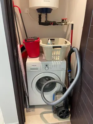 a washing machine with a bucket on top of it at 2BR Dubai Burj View Downtown Skyline with Pool, Gym, & Parking in Dubai