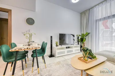 a living room with a table and chairs and a tv at Urban 1BR at Binghatti Stars Dubai Silicon Oasis by Deluxe Holiday Homes in Dubai