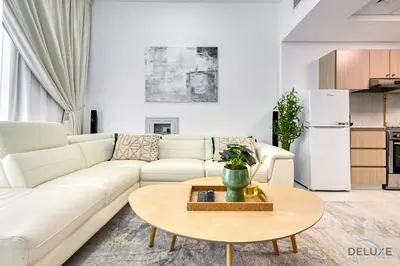 a living room with a white couch and a table at Urban 1BR at Binghatti Stars Dubai Silicon Oasis by Deluxe Holiday Homes in Dubai