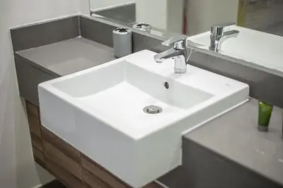 a bathroom with a white sink and a mirror at Apartment on 26th Floor & Beautiful Views (2 adults + 2 kids) in Dubai