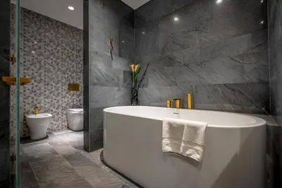 a bathroom with a white tub and a toilet at Daniels Stunning 2BR with Full Sea View at Five in Dubai