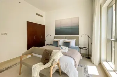 a bedroom with a bed and a couch and a bed at HiGuests - Amazing Apartment overlooking Burj Khalifa! in Dubai