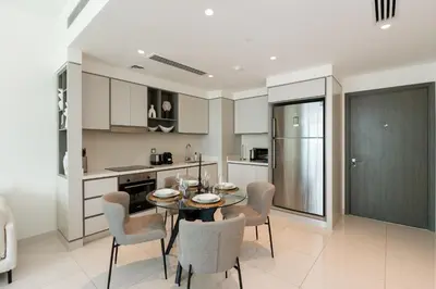 a kitchen and dining room with a table and chairs at Sunrise Bay, Emaar Beachfront Dubai Harbour - Mint Stay in Dubai