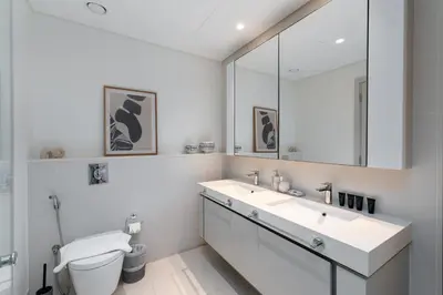 a bathroom with a sink and a toilet and a mirror at Sunrise Bay, Emaar Beachfront Dubai Harbour - Mint Stay in Dubai