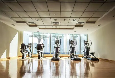 a gym with several exercise machines in a room at Modern 2BR in the Heart of Dubai Marina in Dubai
