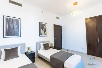 a hotel room with two beds and a closet at Modern 2BR in the Heart of Dubai Marina in Dubai