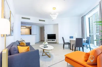a living room with a couch and a table at Modern 2BR in the Heart of Dubai Marina in Dubai
