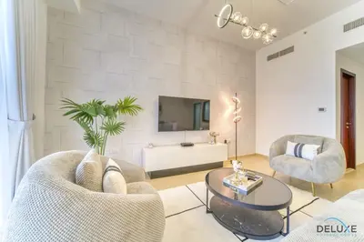 a living room with two chairs and a table at Impeccable 2BR at Bahar 2 JBR by Deluxe Holiday Homes in Dubai